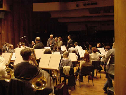 Photo of The Győr Philharmonic Orchestra:  photographed with orchestra manager Gábor Baross; Harold Schiffman; interpreter Szidónia Juhász; David Zsolt Király, producer in Hungary (President, Kiraly Music Network). János Richter Hall, Győr, Hungary (11 October 2002)