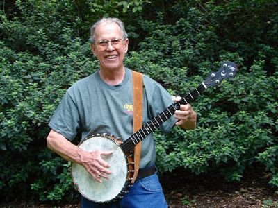 Ome, Sweet Ome! Photo of “Harl” with his 2005 Christmas present: an Ome Jubilee Deluxe open back banjo (and Ome tee-shirt to match!) Tallahassee, Florida (1 September 2006)