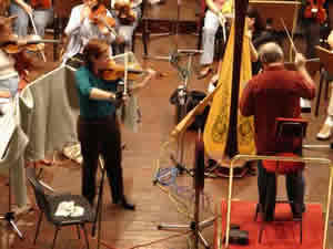 Photo of violinist Rebekah Binford, conductor Mátyás Antal, and members of the Győr Philharmonic Orchestra while recording Schiffman's Concerto for Violin. János Richter Hall, Győr, Hungary (21 September 2007)