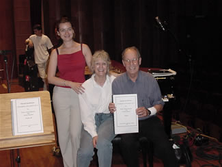 Photo of interpreter Szidónia Juhász, pianist Jane Perry-Camp, composer Harold Schiffman – after recording Chamber Concerto No. 2:  In Memoriam Edward Kilenyi (2000). Janos Richter Hall, Győr, Hungary (15 June 2003) [Photographer unknown]