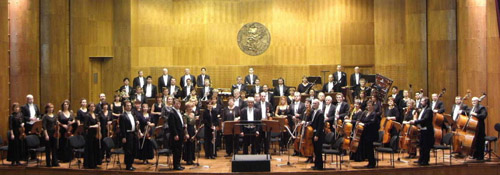 Photo of The Győr Philharmonic Orchestra (Győri Filharmonikus Zenekar) on the stage of the orchestra\'s home: The János Richter Hall, Győr, Hungary. Photograph courtesy of the Győr Philharmonic Orchestra (http://www.gyorifilharmonikusok.hu/)