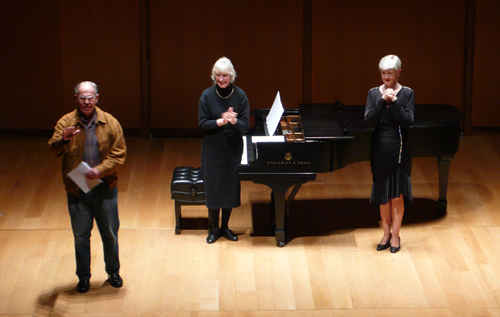 Photo after world première of Blood Mountain (2007);  Harold Schiffman receiving applause from the audience, pianist Jane Perry-Camp, and soprano Gayle Seaton;  Gilder Lehrman Hall (9 March 2008). Photograph by Gerd-Uwe Johnson
