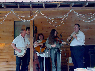 Harold Schiffman playing with Bill and Wilma Millsaps and the Snowbird Mountain Band at the opening of new restaurant, in Reliance, Tennessee. (L to R)  Harold Schiffman (banjo), Stephen Millsaps (bass); Wilma Millsaps (guitar); Abigail Moore (fiddle); Bill Millsaps (mandolin). (25 August 2001)