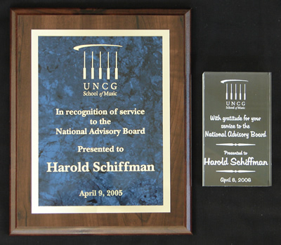 (Left) Photo of Plaque recognizing Harold Schiffman's service to the National Advisory Board of the School of Music, University of North Carolina at Greensboro. (Presented 9 April 2005).  (Right) Photo of eched trophy of gratitude for Harold Schiffman's service to the National Advisory Board of the School of Music, University of North Carolina at Greensboro (Presented 8 April 2006)