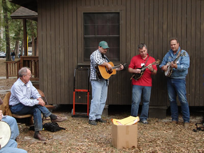 Suwannee Banjo Camp's class "Clawhammer Back-Up from Scratch" under the tutelage of faculty member Mark Johnson, here seen demonstrating what session's name means.  (L to R)  Harold Schiffman, student; Danny Smith, guitar; Scott Anderson, mandolin; Mark Johnson, banjo. Suwannee Banjo Camp, O'Leno State Park, Florida (21 March 2009)